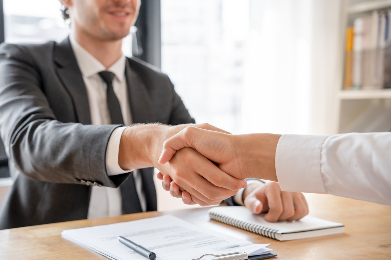 Businessman and Job Seekers Shake Hands after Agreeing to Accept
