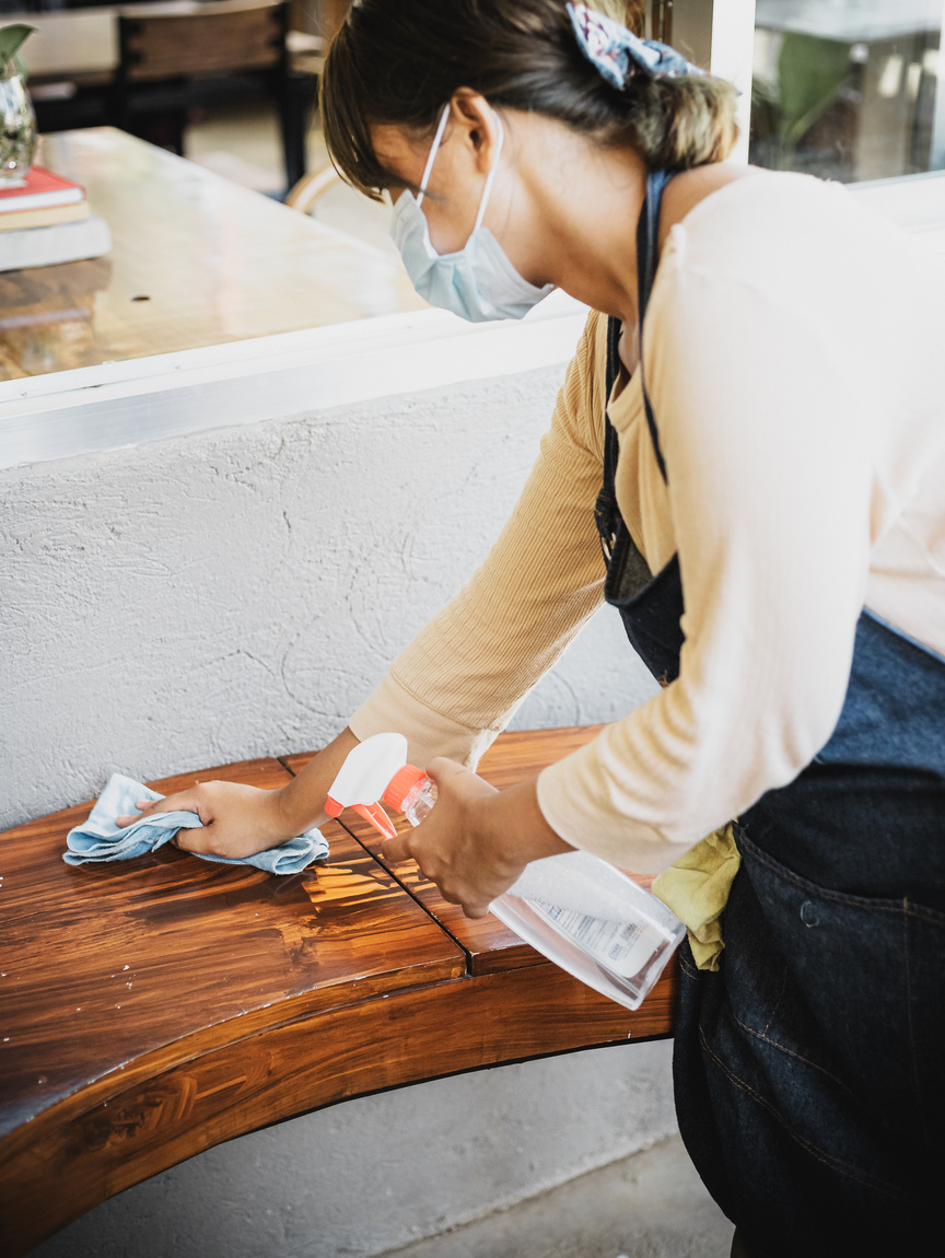 Woman Wearing Face Mask Cleaning Wooden Furniture 